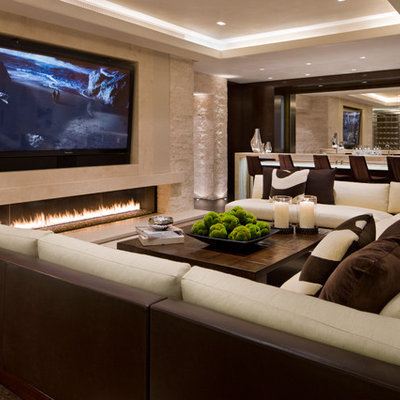 Inspiration for a contemporary family room remodel in Denver with a bar, beige walls, a ribbon fireplace, a stone fireplace and a wall-mounted tv