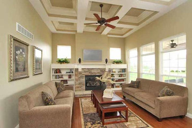 Family room - traditional family room idea in St Louis with a standard fireplace and a stone fireplace
