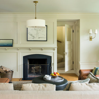 Large ornate open concept light wood floor family room photo in Boston with beige walls, a standard fireplace and a wood fireplace surround
