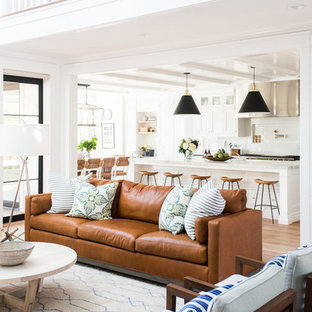Family room - mid-sized coastal open concept medium tone wood floor family room idea in Salt Lake City with white walls and a standard fireplace