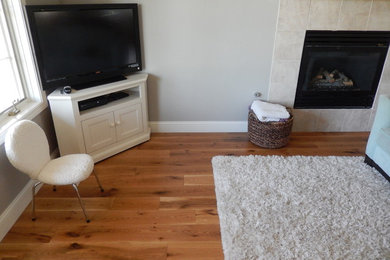 Large minimalist open concept medium tone wood floor and brown floor family room photo in Denver