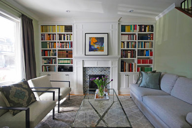 Example of a mid-sized trendy enclosed light wood floor family room library design in Toronto with green walls, a standard fireplace, a brick fireplace and no tv