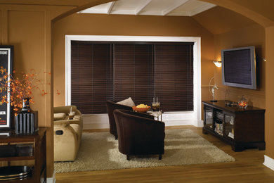 Mid-sized trendy open concept medium tone wood floor family room photo in Denver with brown walls and a media wall