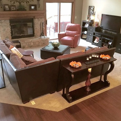 Mid-sized elegant open concept carpeted family room photo in Cleveland with beige walls, a standard fireplace, a stone fireplace and a media wall