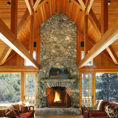 Example of a mountain style open concept family room design in Boston with a standard fireplace and a stone fireplace