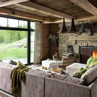 Large mountain style open concept medium tone wood floor and brown floor family room photo in Other with brown walls, a standard fireplace and a stone fireplace