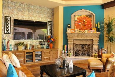 Example of a large tuscan open concept dark wood floor game room design in Phoenix with beige walls, a corner fireplace, a stone fireplace and a wall-mounted tv