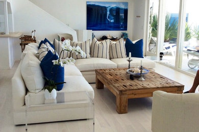 Large beach style open concept light wood floor family room photo in Los Angeles with white walls