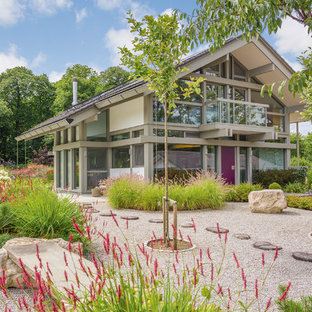 Inspiration for a large contemporary front full sun garden for summer in London with gravel and a garden path.