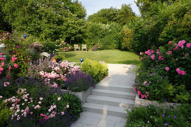 Inspiration för mellanstora moderna bakgårdar i delvis sol på sommaren, med en trädgårdsgång och marksten i betong