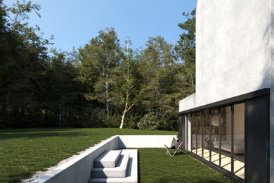 Bild på en mellanstor funkis trädgård i delvis sol längs med huset på sommaren, med en stödmur och marksten i betong