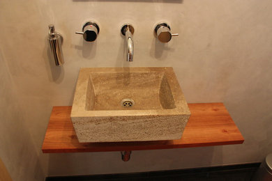 Mittelgroße Moderne Gästetoilette mit Aufsatzwaschbecken und Waschtisch aus Holz in München