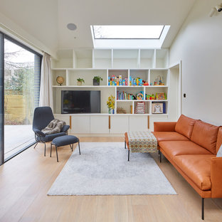 Design ideas for a contemporary games room in London with white walls, light hardwood flooring, a built-in media unit and beige floors.