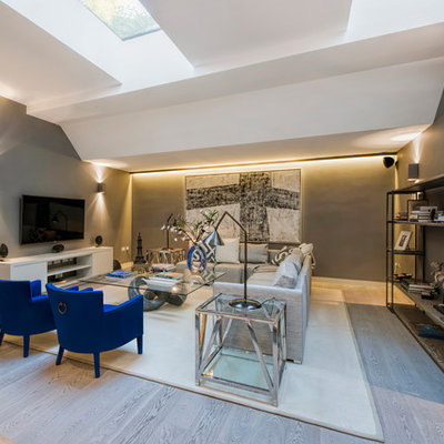 Family room - contemporary open concept family room idea in London with gray walls, no fireplace and a wall-mounted tv