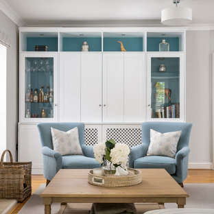 Inspiration for a nautical enclosed games room in Buckinghamshire with grey walls, light hardwood flooring, a standard fireplace and a stone fireplace surround.