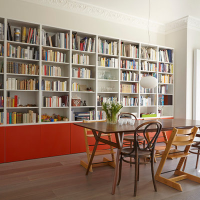 Family room library - large contemporary open concept medium tone wood floor family room library idea in London with white walls, a standard fireplace and a tv stand