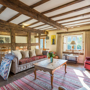 This is an example of a medium sized rural open plan games room in Cardiff with white walls and brown floors.