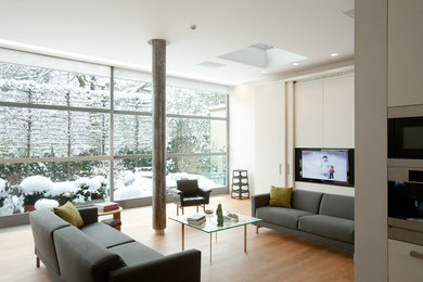 Design ideas for a large modern enclosed games room in London with white walls and beige floors.