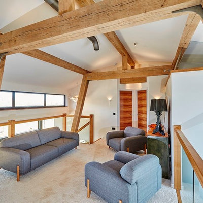 Inspiration for a mid-sized contemporary loft-style carpeted family room remodel in Devon with white walls