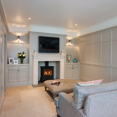Example of a large trendy open concept family room design in Essex with gray walls, a standard fireplace and a wall-mounted tv
