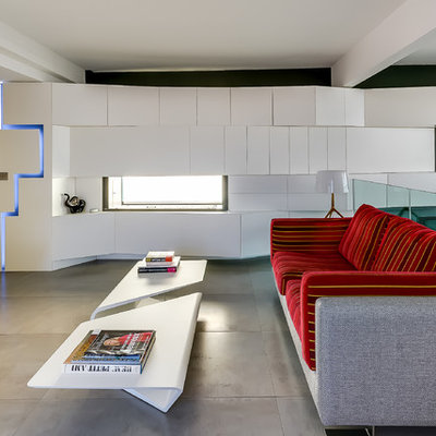 Example of a mid-sized trendy loft-style family room design in Paris with gray walls and a wall-mounted tv