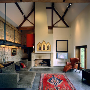 Photo of a large country games room in Other with a standard fireplace, a stone fireplace surround, grey floors and white walls.