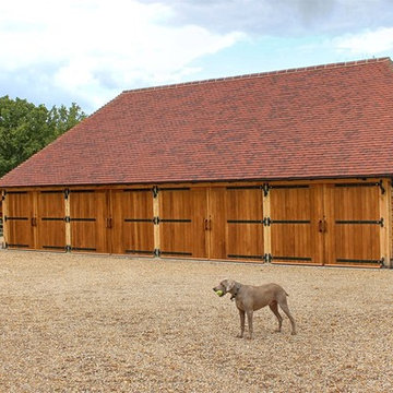 4 Bay garage with a sweeping roof line tied into log-store