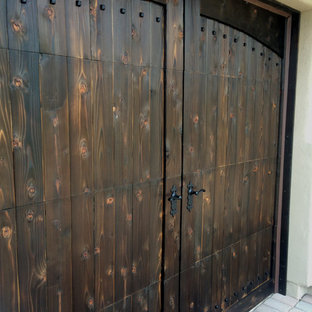 Garage - large rustic attached two-car garage idea in Phoenix