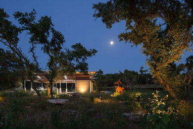 Inspiration for an expansive retro detached carport in Austin with three or more cars.