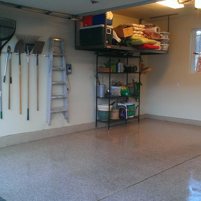 Mid-sized transitional attached two-car garage workshop photo in Denver