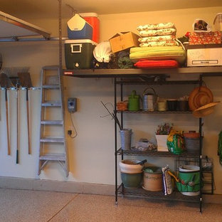 Inspiration for a mid-sized transitional attached two-car garage workshop remodel in Denver
