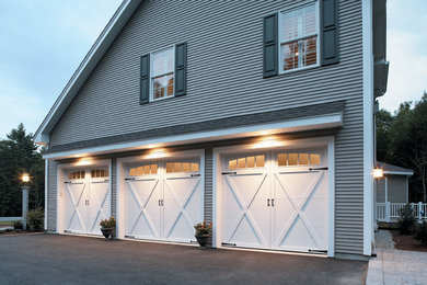 Garage - large traditional attached three-car garage idea in Atlanta