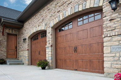 Example of a mid-sized mountain style attached two-car garage design in Other