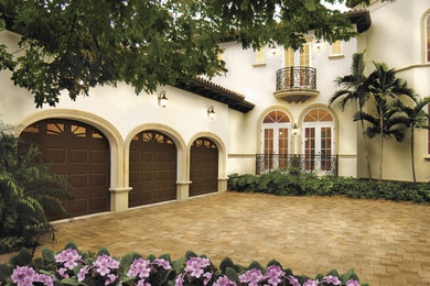 Large tuscan attached three-car garage photo in Miami