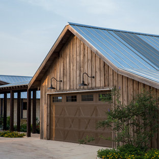 Example of a mid-sized cottage detached two-car garage design in Austin