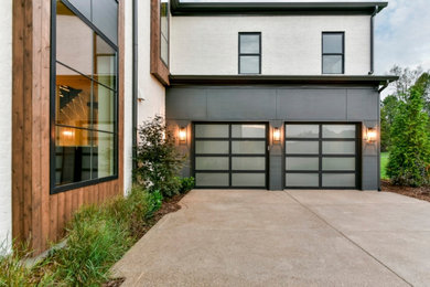 Example of a trendy attached two-car garage design in Louisville