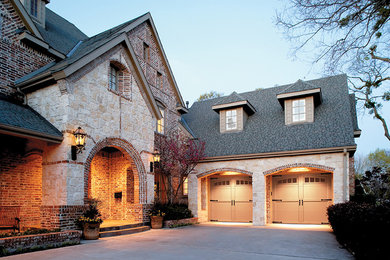 Example of a mid-sized arts and crafts attached two-car garage design in Atlanta