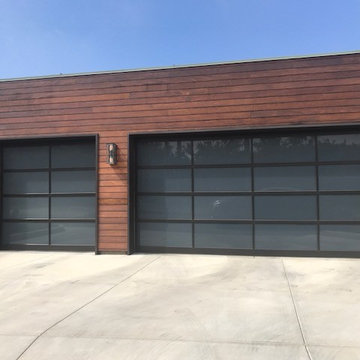 Custom dark aluminum and anodized glass roll up garage doors in Malibu, CA