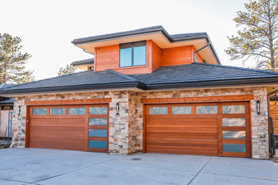 Garage - large modern attached two-car garage idea in Denver
