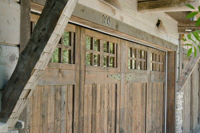 Inspiration for a mid-sized rustic attached two-car garage remodel in Other