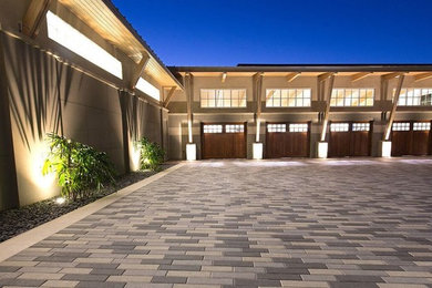 Inspiration for a large contemporary attached four-car garage remodel in Tampa