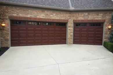 Example of a mid-sized arts and crafts attached two-car garage design in Cleveland