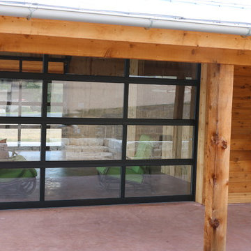 Entertainment room with overhead glass garage door