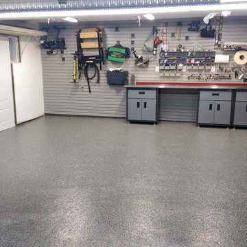 Etobicoke custom garage with epoxy floor, slat walls & cabinets