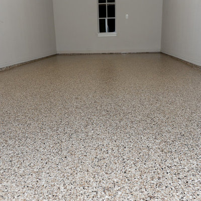 Inspiration for a large industrial attached three-car garage remodel in Dallas