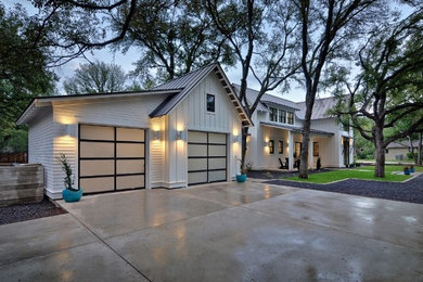 Large trendy attached two-car garage photo in Austin