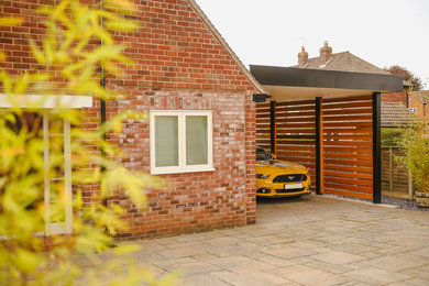 Medium sized contemporary attached single carport in Other.
