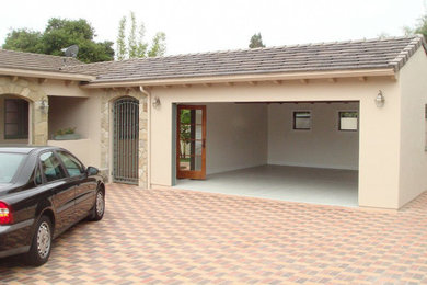 Example of a mid-sized classic attached two-car carport design in Santa Barbara