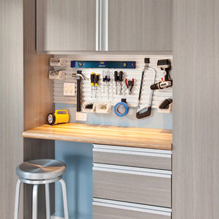 Example of a mid-sized transitional attached two-car garage workshop design in Cleveland