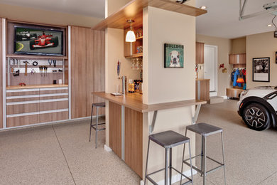 Garage workshop - mid-sized modern attached three-car garage workshop idea in Cleveland